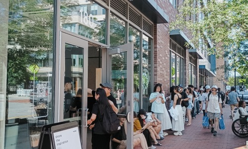 line of people outside of storefront Tea shop in Malden MA
