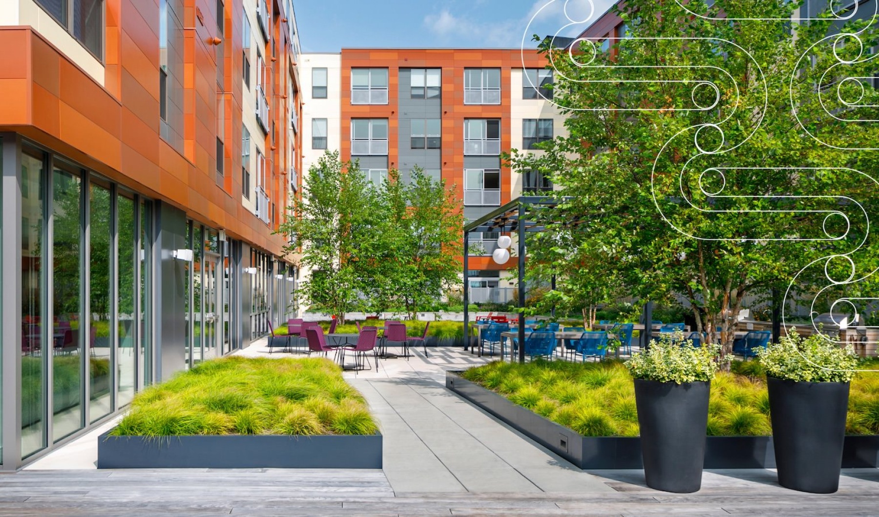 building exterior and a courtyard with trees and plants J Malden Center luxury apartments for rent Malden MA 