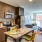 a kitchen with a table and chairs and a living room J Malden Center luxury apartments Malden MA 
