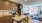 a kitchen with a table and chairs and a living room J Malden Center luxury apartments Malden MA 