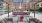 a person lying on a metal hammock in a courtyard J Malden Center apartments on Orange line Boston 