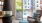 a clubhouse room with fireplace, a chair and a table J Malden Center luxury apartments for rent Boston 