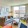 a living room with seating and a large window and a colorful rug J Malden Center luxury apartments Malden MA 