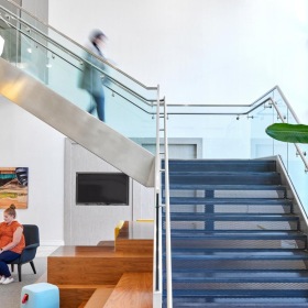 Everything within reach a person walking in entrance staircase J Malden Center luxury apartments for rent Malden MA